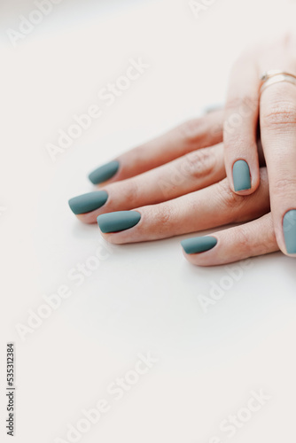 closeup of the hands of a young woman receiving the nail file by a beautician at the beauty salon. Manicure procedure, nail care and grand opening. Quarantine is over, millennial woman in protective.