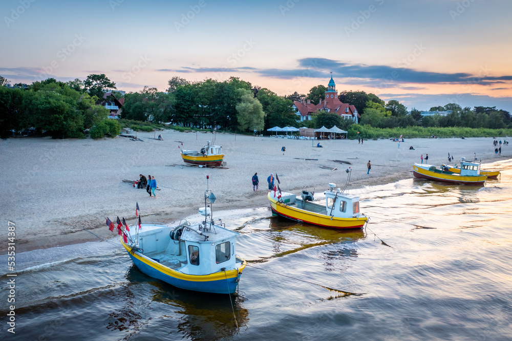 Picturesque fishing boats on the white beach of Sopot, Poland.
