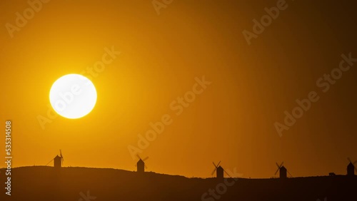 Timelapse of the sun setting behind the iconic Consuegra windmills in Spain