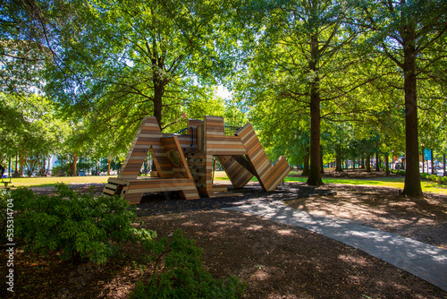 a gorgeous autumn landscape at Woodruff Park with a brown wooden jungle gym in the shape of the letters 