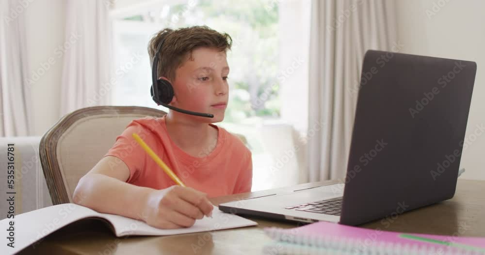 Happy caucasian boy having video call on laptop Happy caucasian boy having video call on laptop