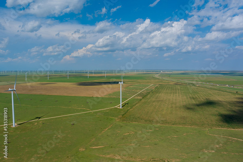 This is wind power electricity farm row of windmill renewable energy turbines in the country of Texas  USA.