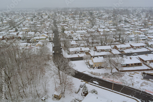 During winter snowfall in New Jersey, small American town house complex with snow covered roofs during snowstorm during the winter photo