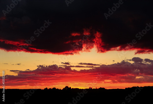 Summer sunset, black and red. Cloudy evening sky. The last sunset of August 31.