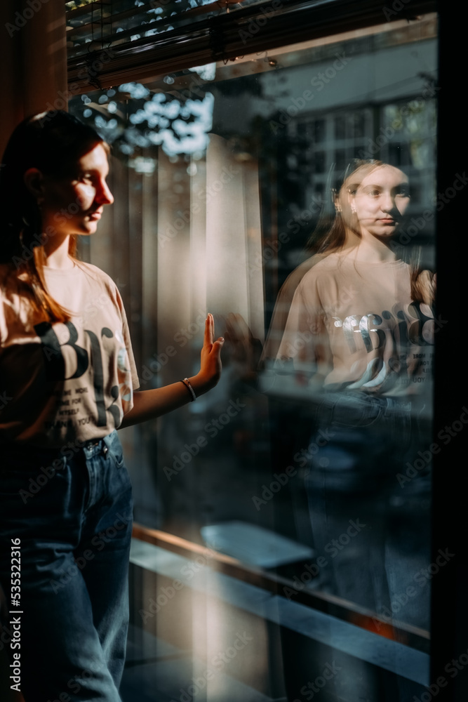 reflection of adolescent in the window reflection of adolescent in the window