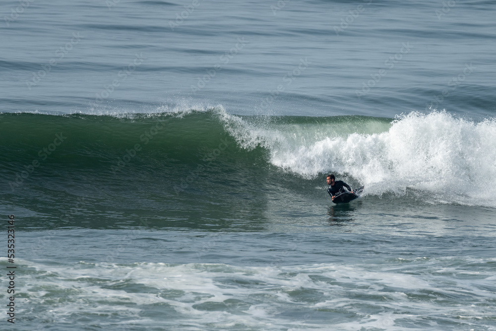 Bodyboarder riding a wave in Furadouro beach, Ovar, Aveiro - Portugal. Bodyboarder riding a wave in Furadouro beach, Ovar, Aveiro - Portugal.