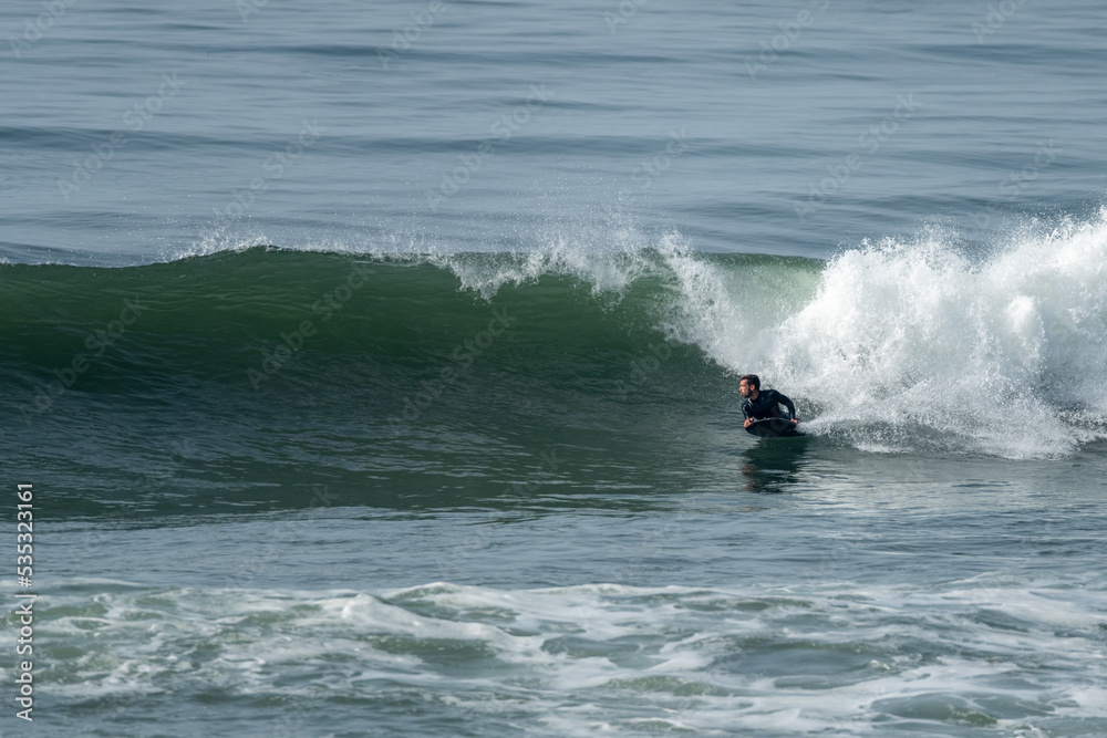 Bodyboarder riding a wave in Furadouro beach, Ovar, Aveiro - Portugal. Bodyboarder riding a wave in Furadouro beach, Ovar, Aveiro - Portugal.