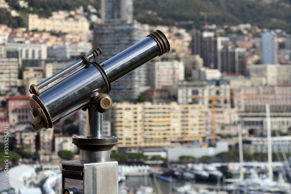Monaco, Monaco - 02.10.2022: Morning view of the Principality of Monaco from the Prince's palace, with a telescope in the foreground, partly out of focus Monaco, Monaco - 02.10.2022: Morning view of the Principality of Monaco from the Prince's palace, with a telescope in the foreground, partly out of focus