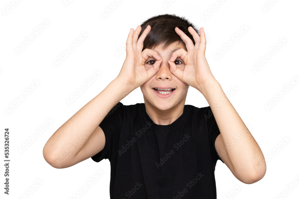 Fototapeta premium A 9-year-old boy in a black t-shirt on a white background and depicts a monkey