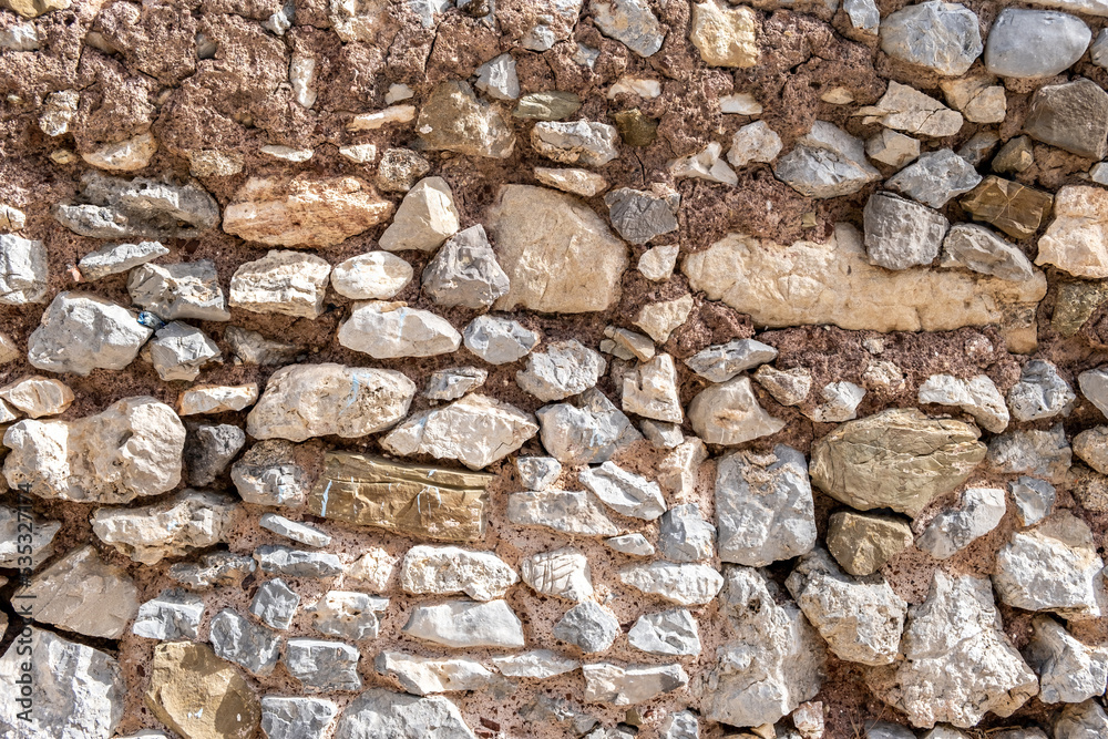 Rocky wall construction background texture. Old grey beige rough stonewall with cement. Copy space Rocky wall construction background texture. Old grey beige rough stonewall with cement. Copy space