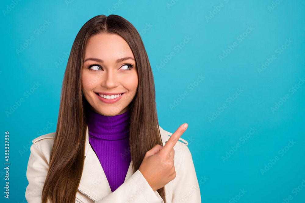 Close up photo of cheerful nice lady arm finger show empty space offer store mall sale trendy clothes isolated on blue color background Close up photo of cheerful nice lady arm finger show empty space offer store mall sale trendy clothes isolated on blue color background
