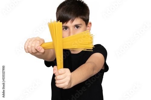 Photo of adorable young happy boy looking at camera.Isolated on the white background. Kid doing creative activity with pasta