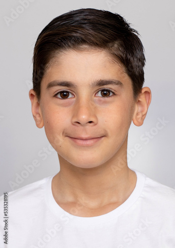 Photo of adorable young happy boy looking at camera.Isolated on the white background