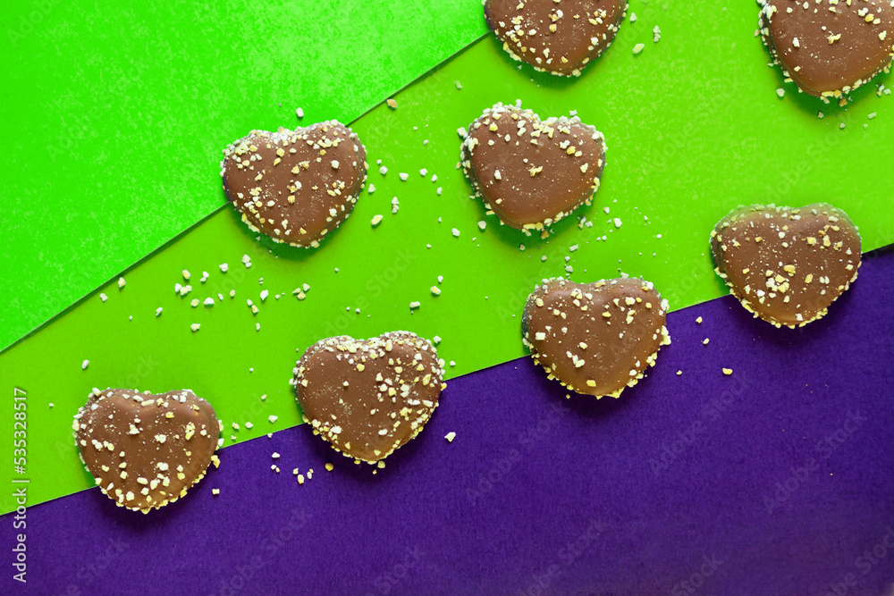 chocolate cookies hearts with nuts on colorful background. flat lay on colored paper. Chocolate chips chocolate cookies hearts with nuts on colorful background. flat lay on colored paper. Chocolate chips