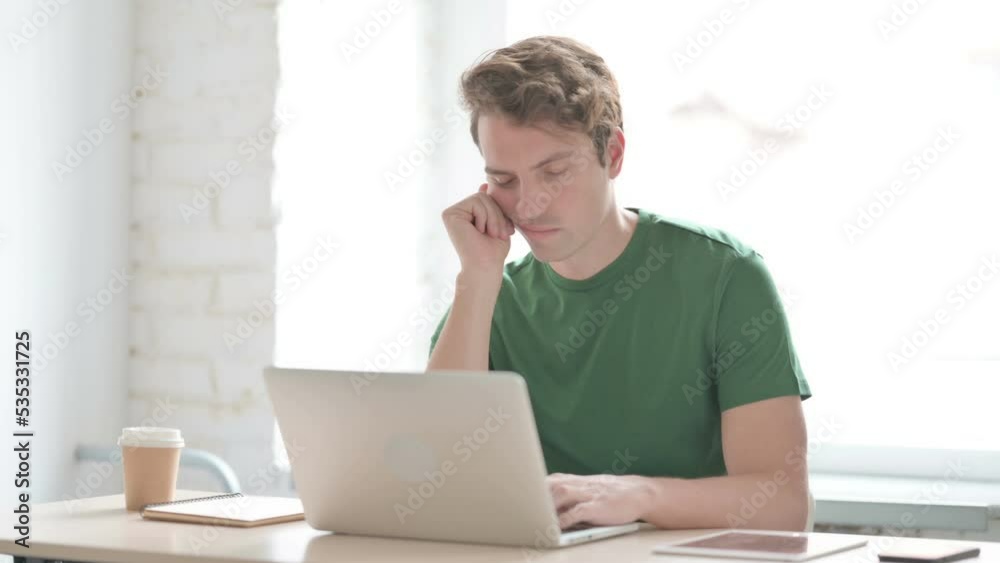 Tired Young Man Sleeping while at Work Tired Young Man Sleeping while at Work