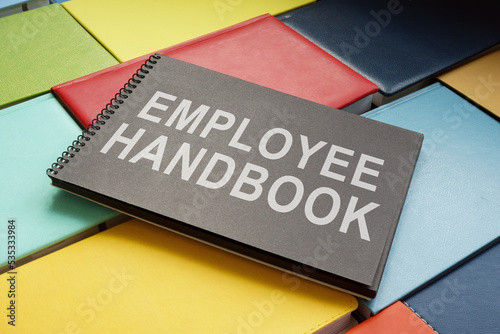An employee handbook on the colorful books. photo