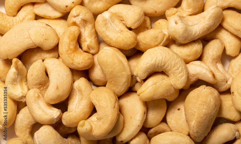 Cashew nuts as a background, top view. Cashew isolated on white background. Healthy foods. Cashew nuts as a background, top view. Cashew isolated on white background. Healthy foods.