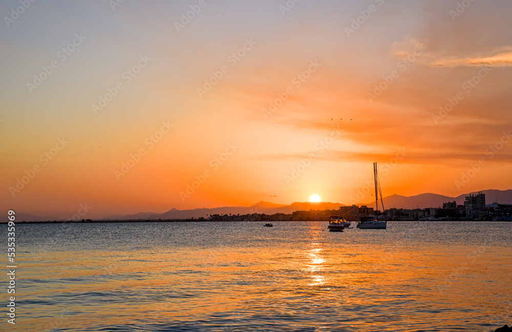 Beautiful colorful sunrise on the sea with bright orange color and sun