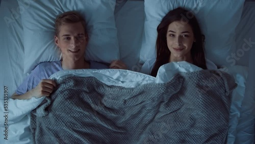 Couple Going to Sleep at Night. Couple Lying in Bed. Lovely Couple Looking at Eact Other in Bed. Bed Time. Up Down View Shot on RED