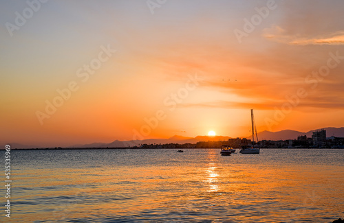 Beautiful colorful sunrise on the sea with bright orange color and sun © EMILIA