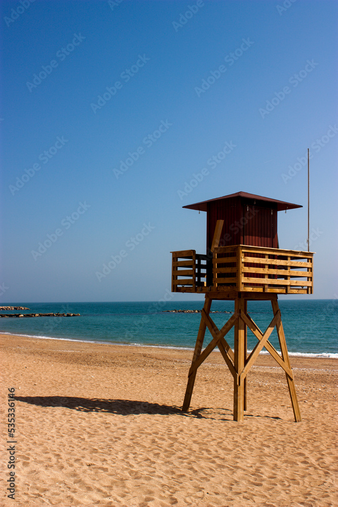 watchtower on the beach, lifeguard post, Mediterranean in winter on a sunny day, solitude and tranquility.
