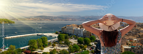 Tourism in Corfu, Greece. Back view of traveler girl enjoying view of Corfu. Conceptual image