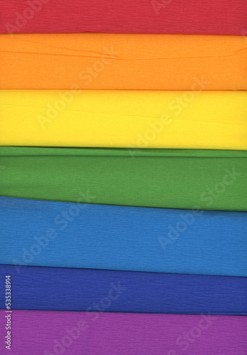 Colorful crepe rolls abstract background. 7 rolls of crepe paper horizontal. In the colors of the rainbow.