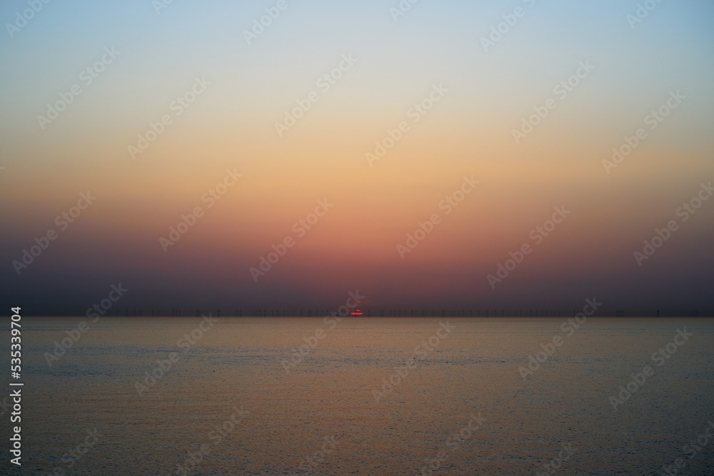 Pastel coloured sunrise over the sea