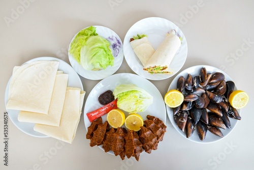 Table scene of assorted take out or delivery foods. Traditional Turkish cuisine. Various Turkish meal and appetizers. Top down view on a table. photo