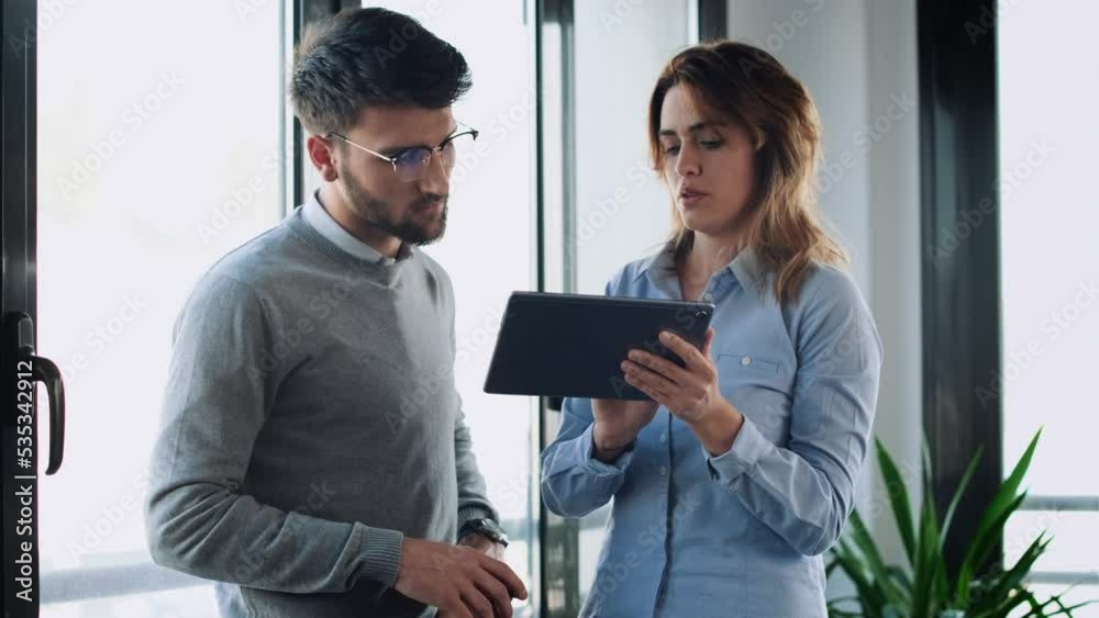 Video of happy business people working with digital tablet while discussing together in conference room at modern startup Video of happy business people working with digital tablet while discussing together in conference room at modern startup