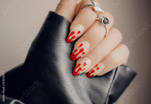 Beautiful art manicure. Halloween manicure design ideas. Fashionable valentines day nail design. Stylish red nails. Close up photo.