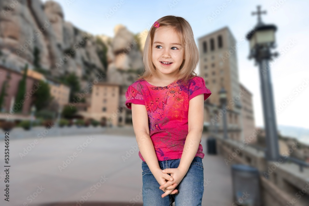 A cute small kid is posing on background