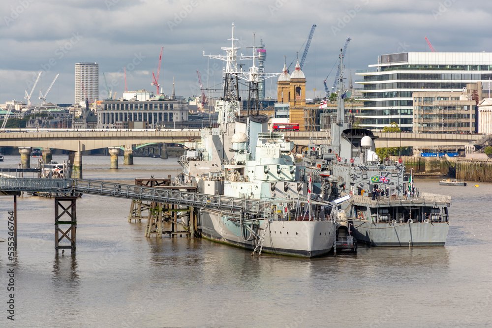 Warship on the Thames against the backdrop of city buildings, urban landscape