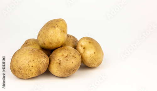 A mountain of new potatoes on a white background