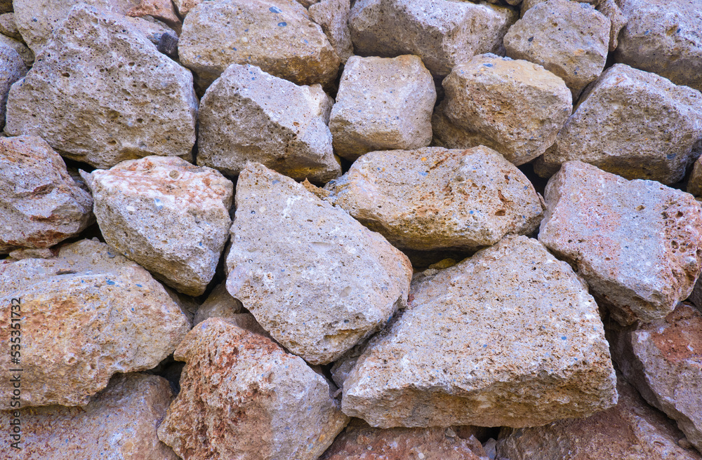 Texture of a stone wall. Old castle stone wall texture background. Brown, sienna large stones. Part of a stone wall, for background or texture Texture of a stone wall. Old castle stone wall texture background. Brown, sienna large stones. Part of a stone wall, for background or texture