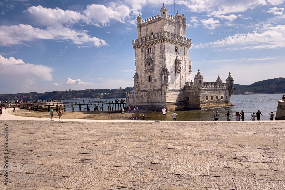 Tourists walking nearby Belem tower in Lisbon