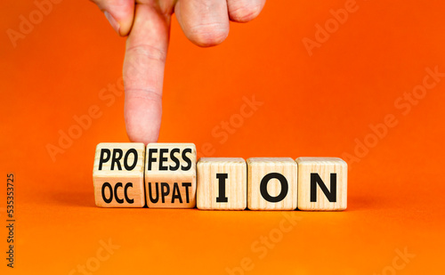 Profession and occupation symbol. Concept words Profession and Occupation on wooden cubes. Businessman hand. Beautiful orange background. Business profession and occupation concept. Copy space.