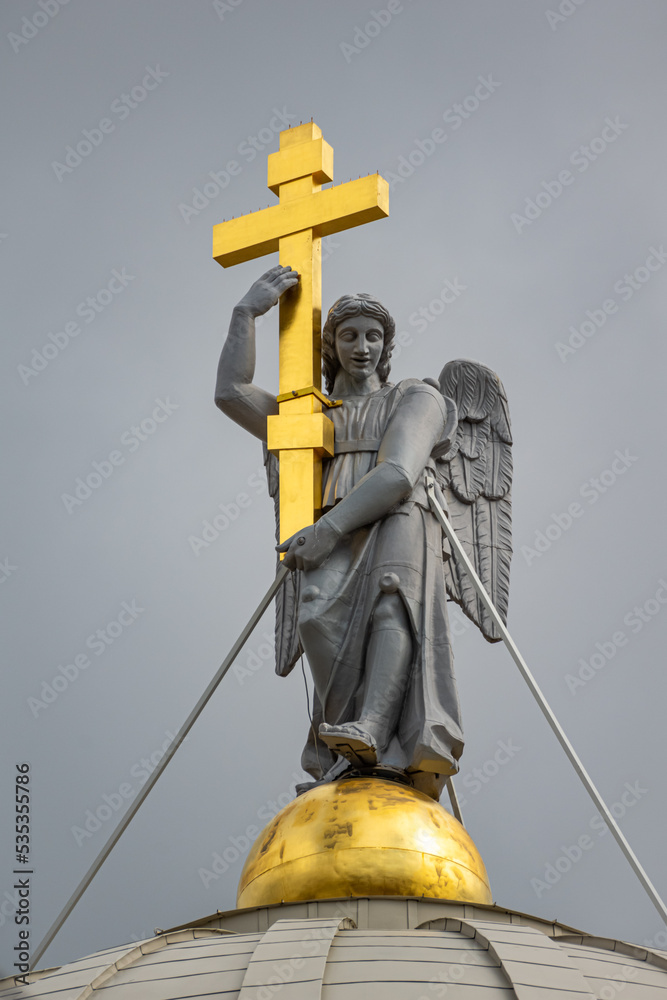 Sculpture of Angel with a golden cross on the dome of the church, Saint Petersburg, Russia