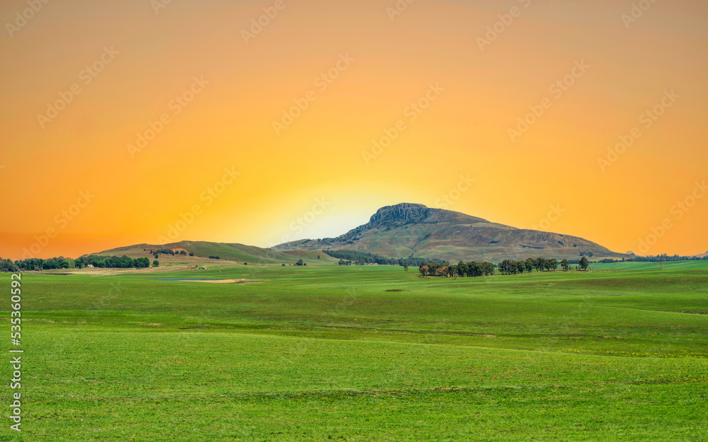 grasslands and mountain of drakensberg during sunset in KwaZulu-Natal, South Africa