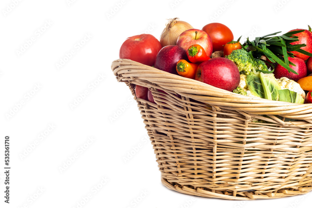Assorted organic vegetables and fruits in wicker basket isolated on white background. Space for text. Assorted organic vegetables and fruits in wicker basket isolated on white background. Space for text.