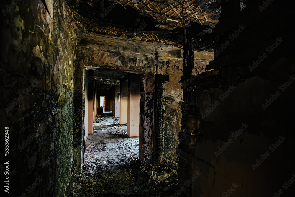 Burnt building interior. Ruined coridor walls in black soot. Consequences of fire Burnt building interior. Ruined coridor walls in black soot. Consequences of fire