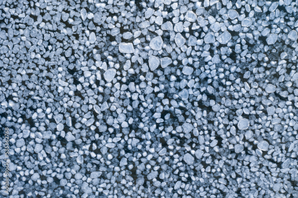 abstract texture of broken ice and dark water. background of the frozen surface of a clean lake or river abstract texture of broken ice and dark water. background of the frozen surface of a clean lake or river