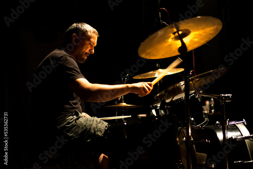 Drummer in rock band recording music in the professional recording studio photo