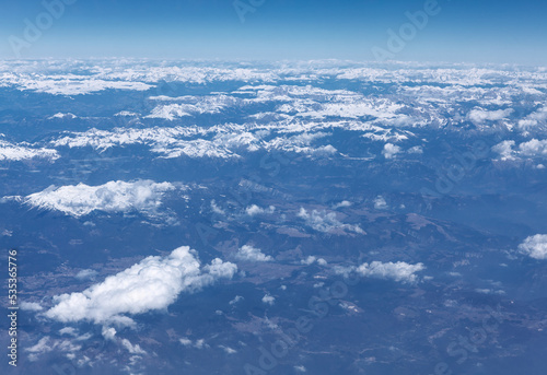 Panoramic snowy high mountains . Winter aerial view of mountains . Flight over the ridge 