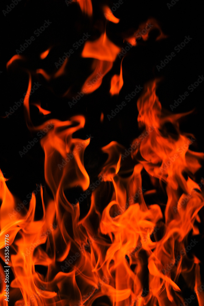 Fire. Flames on a black background. Tongues of flame, sparks close-up.fiery wallpaper. Fire. Flames on a black background. Tongues of flame, sparks close-up.fiery wallpaper.