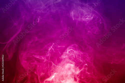 Colorful smoke on a black background. Rainbow abstract light texture smoke background.