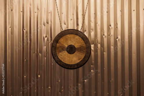 Gong hanging over metal background 
