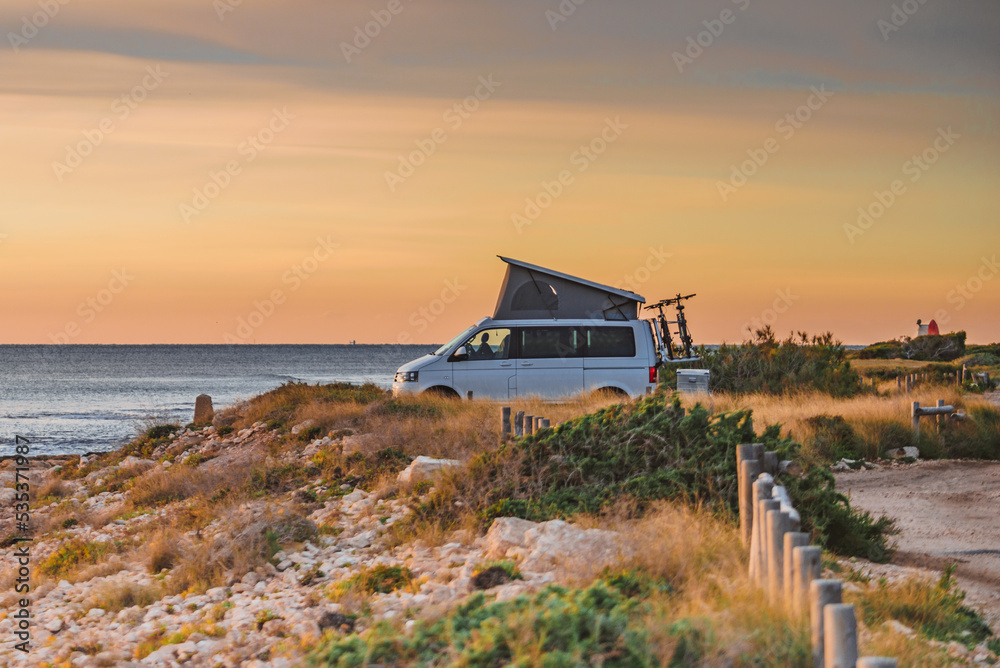 Van camper with tent on roof top camp on nature
