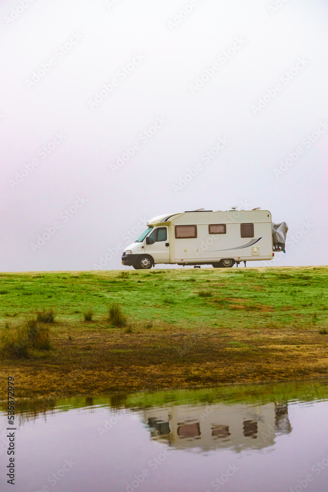 Camper rv camping at lake shore. Foggy day Camper rv camping at lake shore. Foggy day