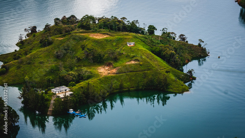 House in an Islet Lonely on a Secluded Island Middle of the Crystal Lake Aerial Cinematic Vision of a Green Relaxing Holiday in Colombia near Guatape Medellín